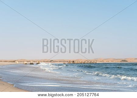 Pillars of the old railroad bridge over the mouth Swakop River at Swakopmund in the Namib Desert on the Atlantic Coast of Namibia
