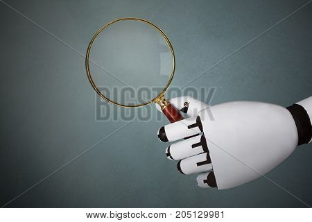 Close-up Of Robot's Hand Holding Magnifying Glass