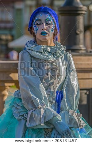 TIMISOARA ROMANIA - MARCH 31 2017: Living statue of a woman dressed with winter elements and present on the street inside the CheckART Carnival organized by the City Hall Timisoara. Union Square.