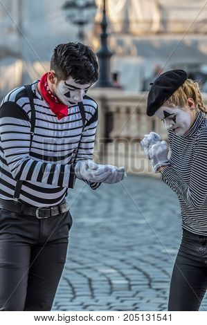 TIMISOARA ROMANIA - MARCH 31 2017: Pantomime couple with painted face present on the street inside the CheckART Carnival organized by the City Hall Timisoara. Union Square.