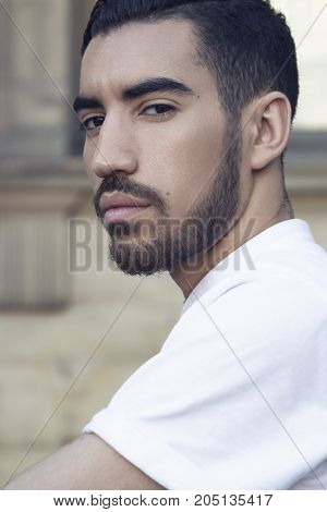 Street fashion concept. Portrait of elegant young handsome man. Paris buildings as background.