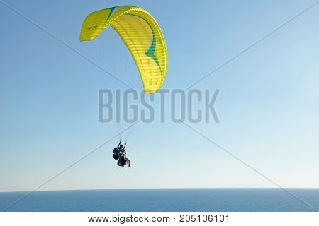 NETANYA, ISRAEL - AUGUST 29, 2015: Paraglider on Mediterranean sea coast, Netanya beach, Israel. Coast and quay of Netanya is popular place for paragliding