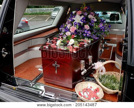 closeup shot of a colorful casket in a hearse or chapel before funeral or burial at cemetery