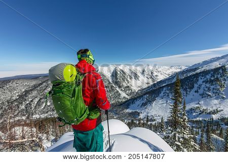 Man Standing At Top Of Ridge. Ski Touring In Mountains. Adventure Winter Freeride Extreme Sport.
