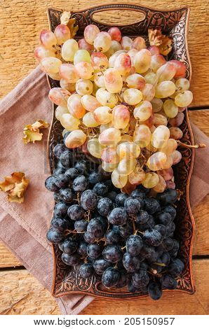 Two Type Of Fresh Ripe Grapes Blue And Green On A Vintage Old Tray. Close Up And Top View.