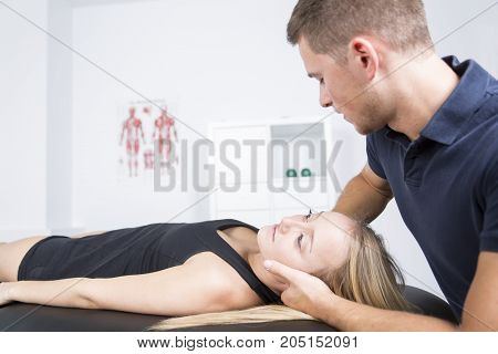 A male physio therapist and woman helping patient
