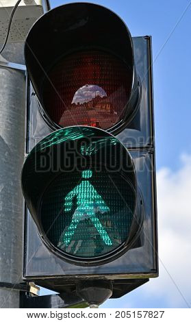 Green traffic light at the pedestrian road cossing