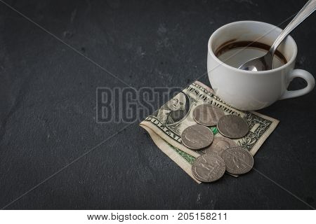 Empty coffee cup with cash and tip