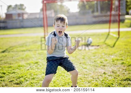 A Young caucassian soccer player football outside