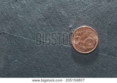 5 euro coin on a grey background