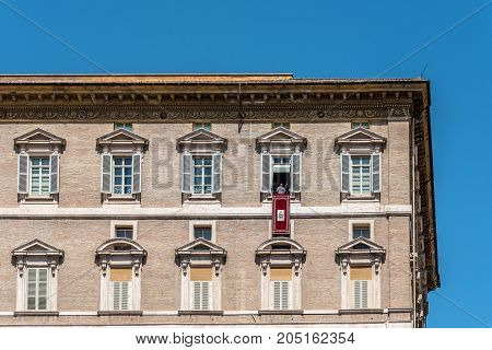 Rome, Italy - August 22, 2016:  Vatican Basilica of St Peter from the  Square. Pope Franciscus blessing the pilgrims from balcony.