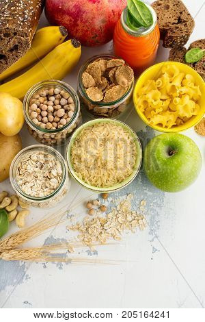 Assortment of products rich of complex carbohydrates. Healthy food on white stone background. Space for text