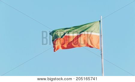 Flag of Tatarstan flutters in the wind in front of blue sky, Kazan - capital of Tatarstan republic - part of Russia, telephoto