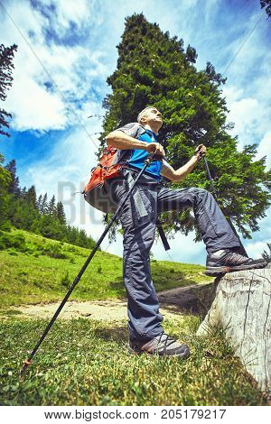 Hiking in the mountains with a backpack in the summer.