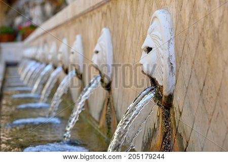 Old venetian fountain with lion heads springs pure drinking water in Spili Crete island Greece
