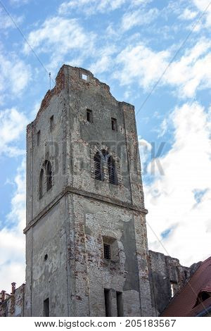 In the foreground is Breclav castle in the background is blue sky with white clouds.
