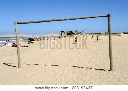 Barra de Valizas Uruguay - 11 february 2011: people playing football on the beach of Barra de Valizas on Uruguay
