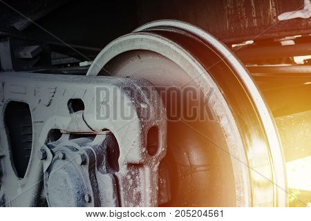Railway transportation background. Train wheel close up. Heavy metallic construction