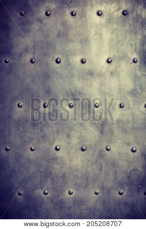 grunge metal plate or armour texture with rivets as background