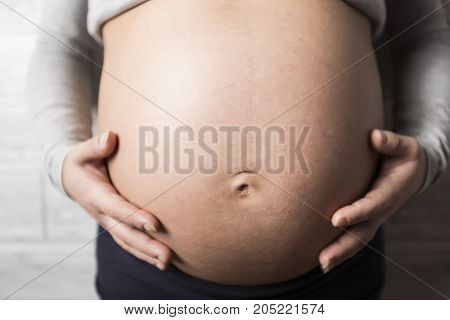 A nice Pregnant woman in baby room