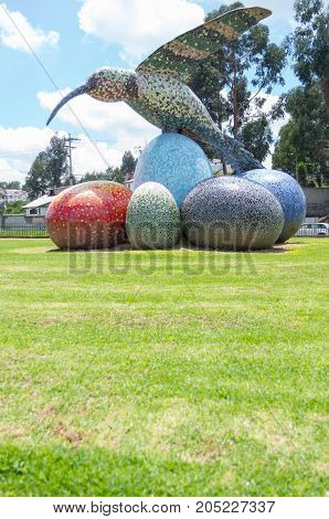 Quito, Ecuador - 28 APRIL, 2015 Historic monument of a huge colorful hummingbird sculpture located in the valley of Los Chillos.