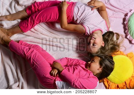 Girls Lie On White And Pink Bed Sheets Bending