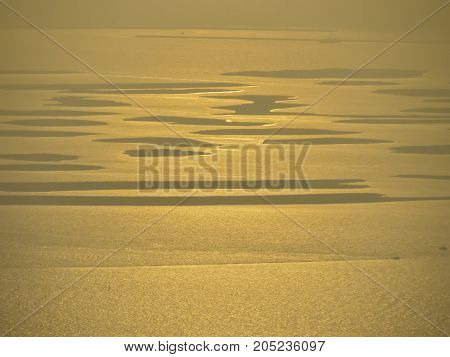 Setting Sun reflects from ocean surface creating beautiful effect