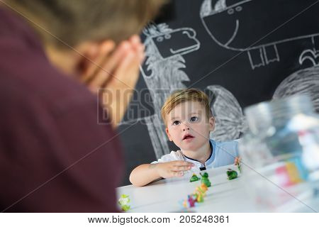 Cute little playfull toddler boy at child therapy session. Private one on one homeschooling with didactic aids.