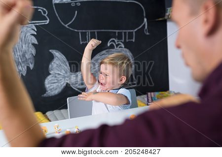Cute little playfull toddler boy at child therapy session. Private one on one homeschooling with didactic aids.