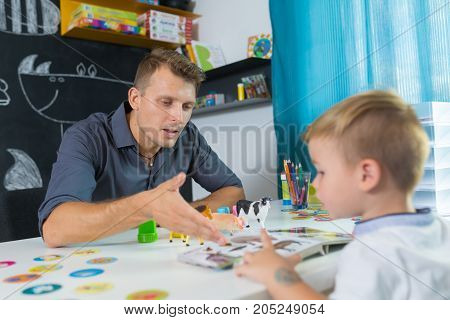 Cute little boy at speech therapist session. Private one on one homeschooling.