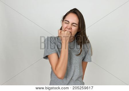 Young Girl Is Biting Her Fist