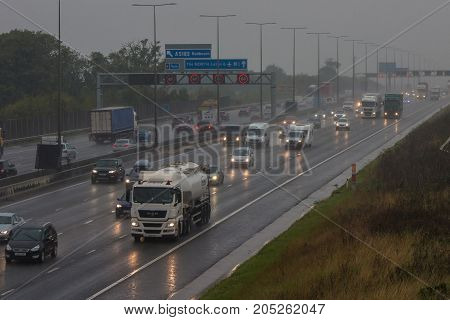 Redbourn UK - September 21 2017: Traffic on busy British motorway M1 in a bad rainy weather.