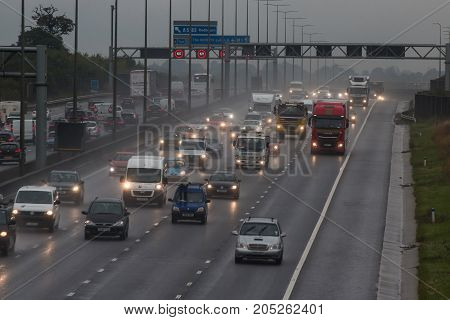 Redbourn UK - September 21 2017: Traffic on busy British motorway M1 in a bad rainy weather.