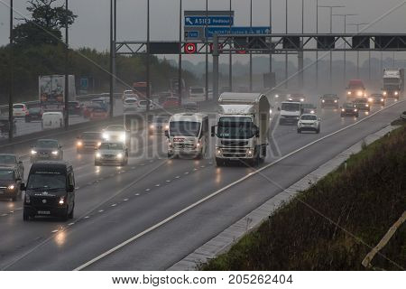 Redbourn UK - September 21 2017: Traffic on busy British motorway M1 in a bad rainy weather.