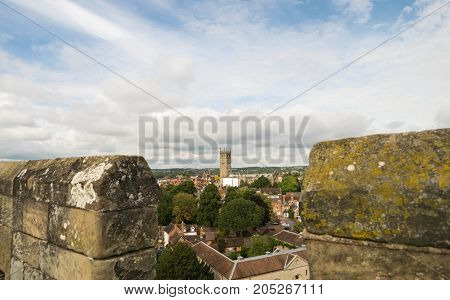 Warwick, United Kingdom - September 19, 2016: View of the Medieval castle tower and gatehouse from within the castle gardens and people enjoying the setting, Warwick, Warwickshire