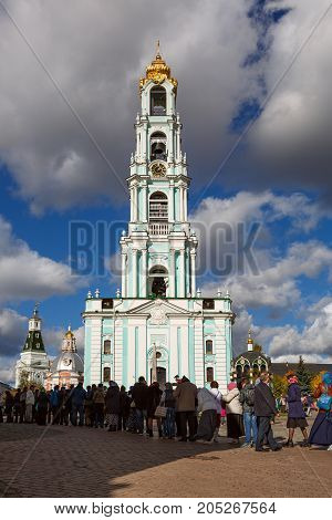 SERGIYEV POSAD/ RUSSIA - OCTOBER 1, 2016. People waiting in a line to see the holy relics in the Trinity Lavra of St. Sergius in front of the large Bell Tower. Sergiyev Posad, Moscow region, Russia