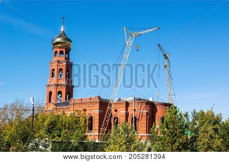 Construction Crane Near The Church Under Construction