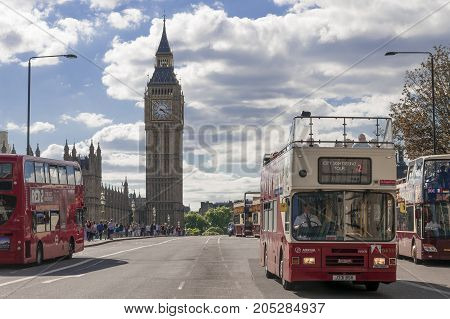 LONDON UK - AUGUST 11 2013; Buses cross Westminster Bridge in London on a sunny afternoon.
