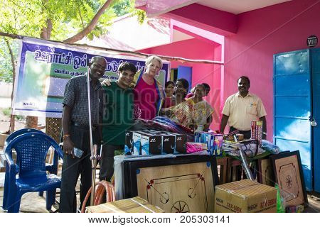 PONDICHERY PUDUCHERY INDIA - SEPTEMBER 04 2017. Outdoor meeting of the children of the school with uniforms sitting on the floor waiting for sport equipments as a gift from an association.