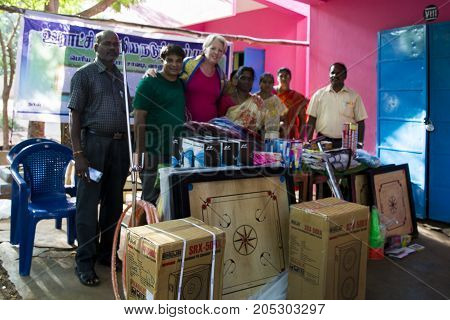 PONDICHERY PUDUCHERY INDIA - SEPTEMBER 04 2017. Outdoor meeting of the children of the school with uniforms sitting on the floor waiting for sport equipments as a gift from an association.