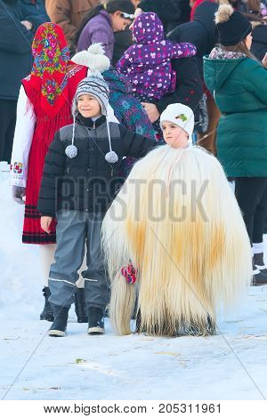 Razlog, Bulgaria - January 14, 2017: Children in traditional carnival kuker costumes at Kukeri festival Starchevata