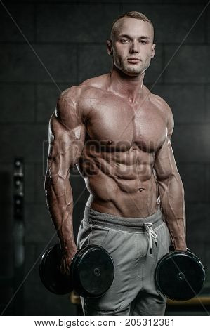 Attractive Model Young Man Training In Gym