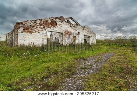 The old destroyed cowshed of the Soviet period in Russia