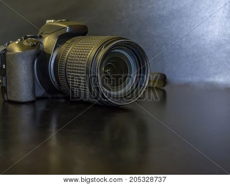 One black lens on the black bacjground black camera on a black background