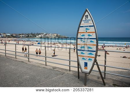 SYDNEY,NSW,AUSTRALIA-NOVEMBER 21,2016: Surfers Code sign with tourists at Bondi Beach in Sydney, Australia.