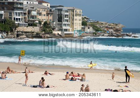 SYDNEY,NSW,AUSTRALIA-NOVEMBER 21,2016: Surfing, waterfront architecture and rocky cliffs on the Pacific Ocean coast at Bondi Beach in Sydney, Australia.