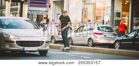 Professional Skater Riding Skate On Streets Through Cars And Traffic