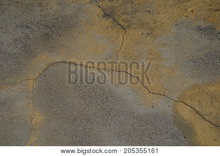 Cracked concrete wall covered with cement - background