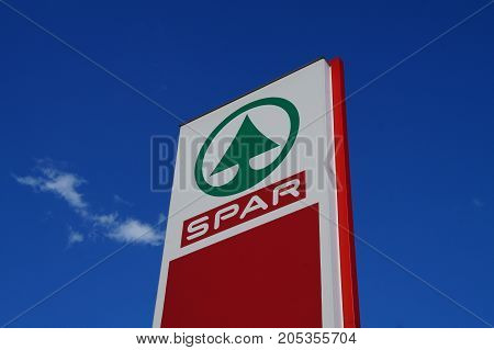Lesce, Slovenia - August 11, 2017: SPAR supermarket logo against a blue sky. Spar is a Dutch multinational retail chain with stores in 35 countries worldwide.