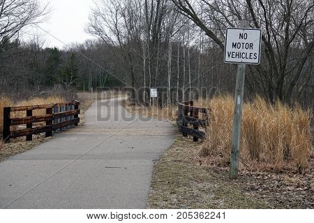 BAY VIEW, MICHIGAN / UNITED STATES - MARCH 30, 2017: A sign indicates that motor vehicles are prohibited on the Little Traverse Wheelway.